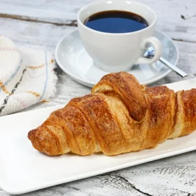 Enjoy a freshly baked croissant paired with a perfect cup of coffee for a delightful breakfast.